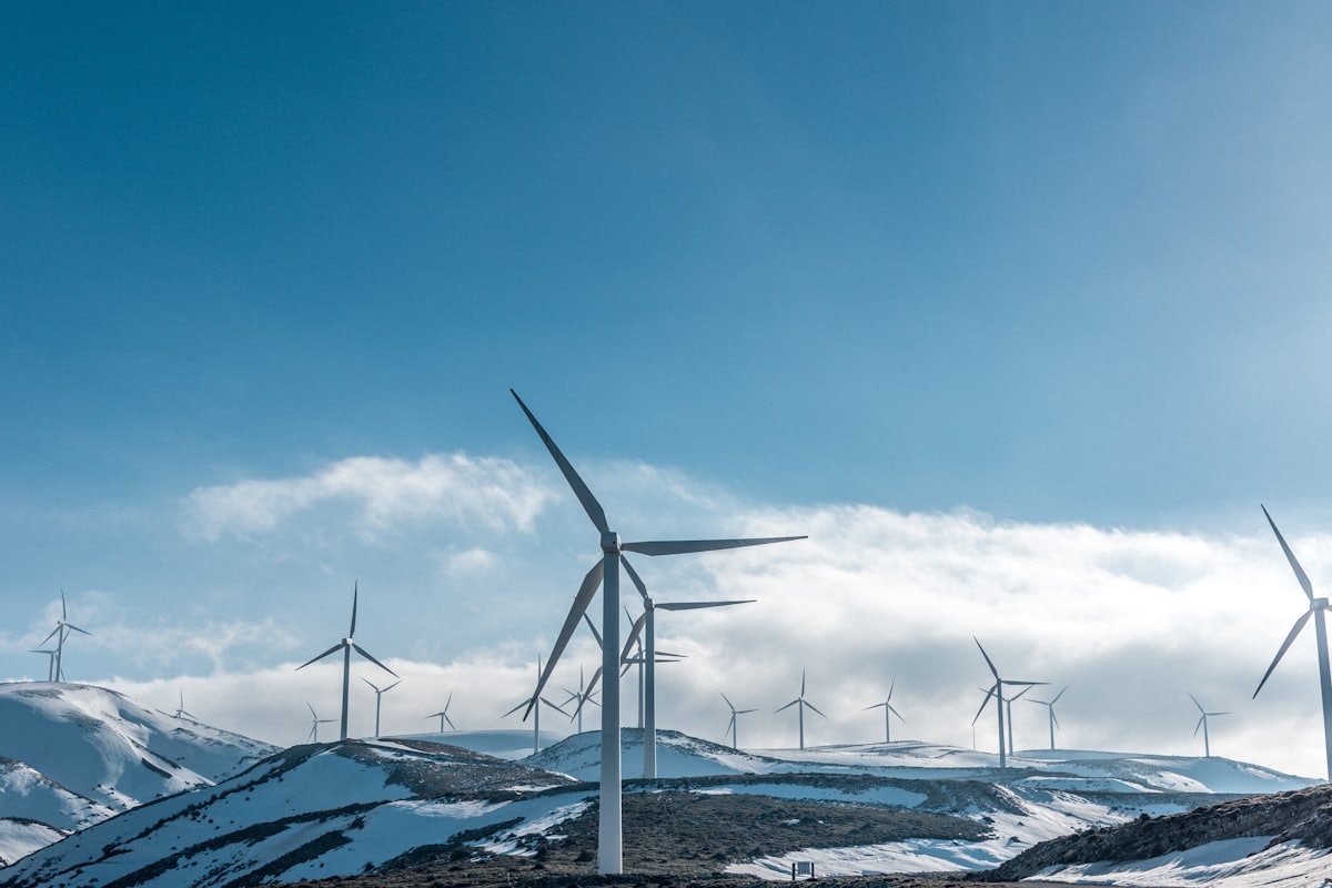 Wind turbines on a ridge under clear sky