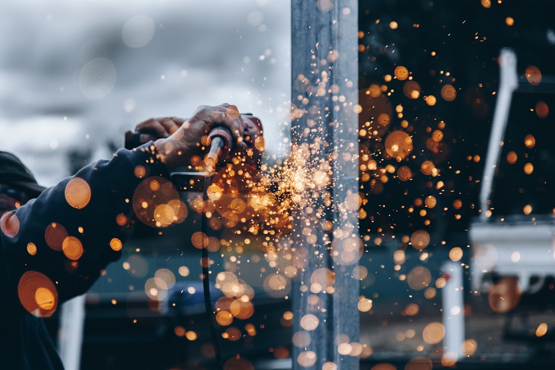 Sparks from grinding a heavy-wall steel weld