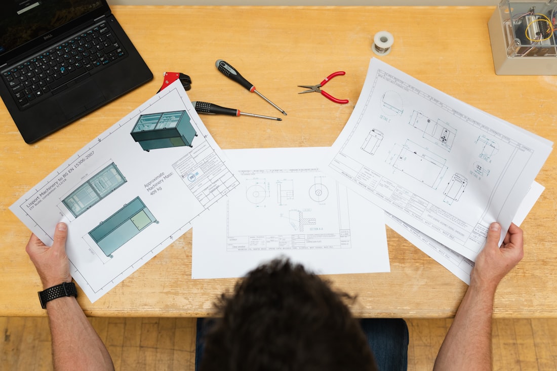 Engineer comparing recreated drawings against a component